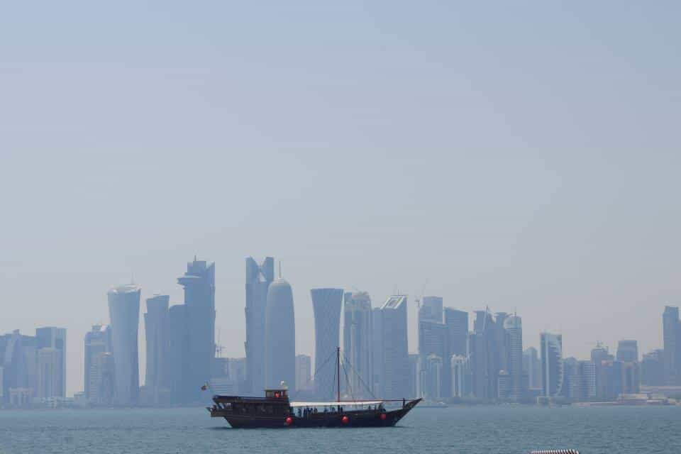 Taking a Dhow Cruise Qatar in front of the West Bay skyline