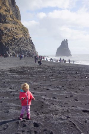 Toddler on Black Beach Iceland - iceland with a baby or toddler 