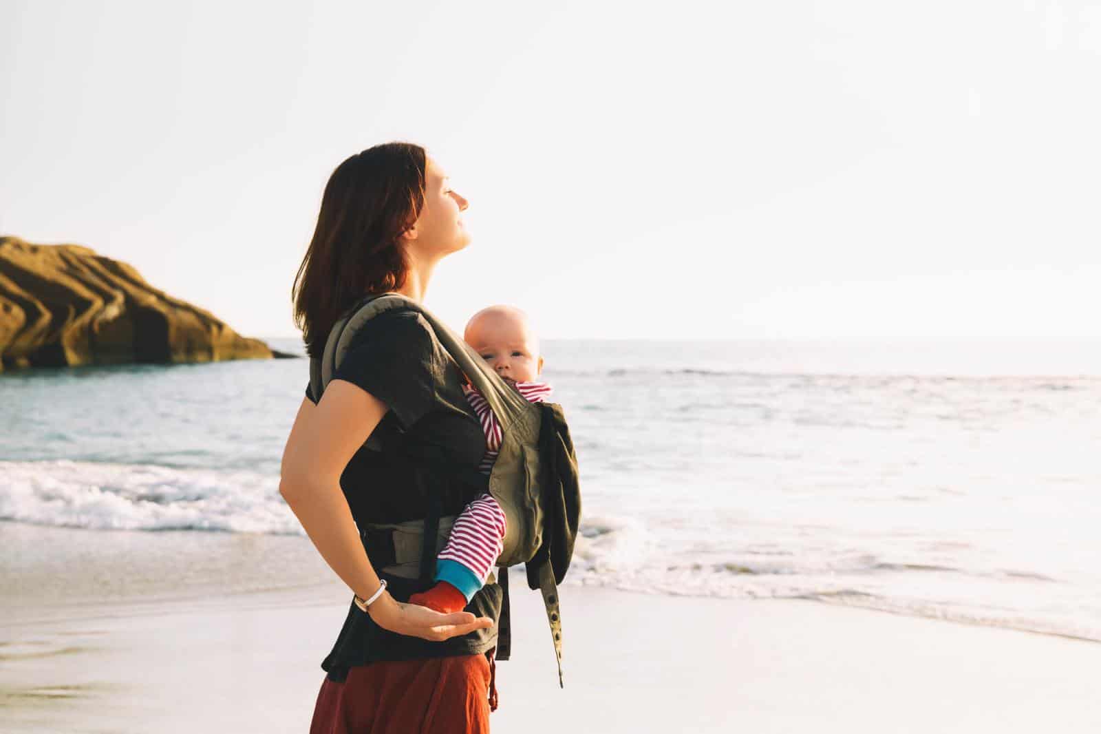 Woman Babywearing on beach - The best baby carriers for hot weather