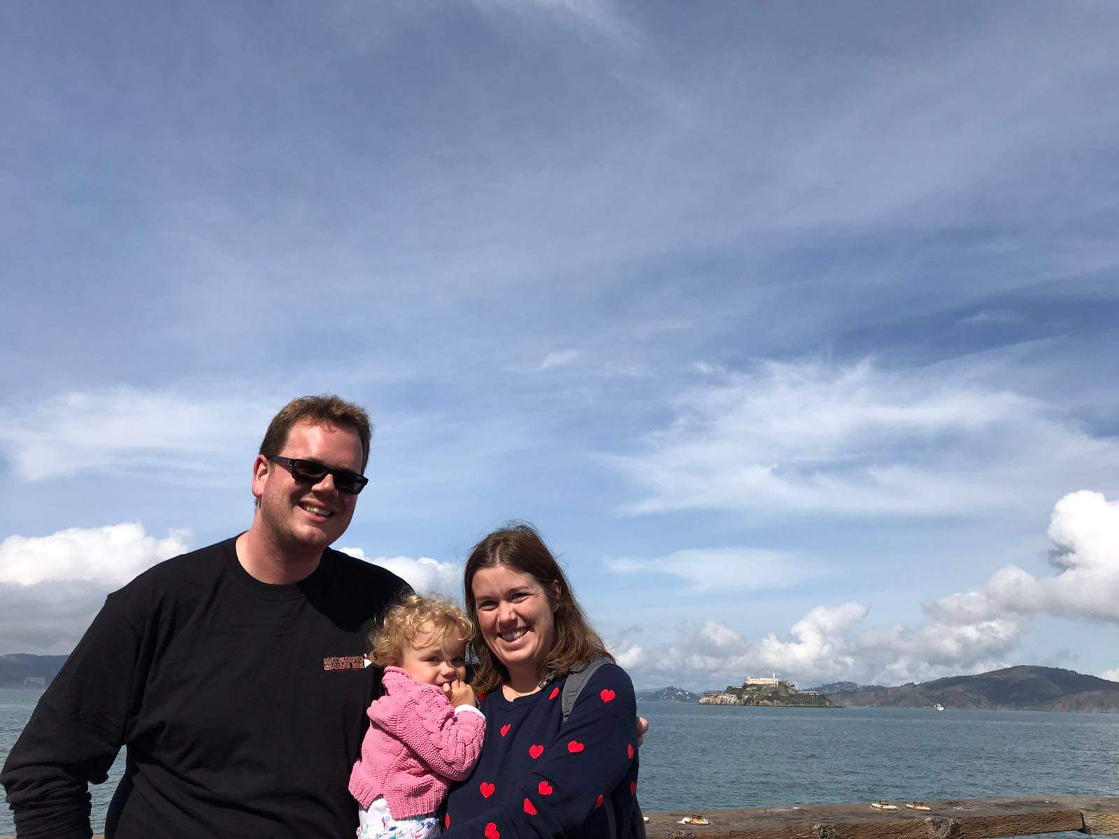 Family with a toddler in San Francisco with Alcatraz in the background