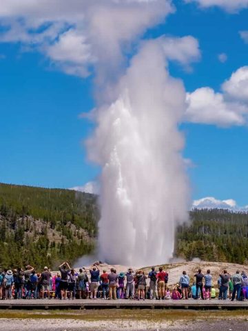 Crowds watching the eruption of Old Faithful in Yellowstone