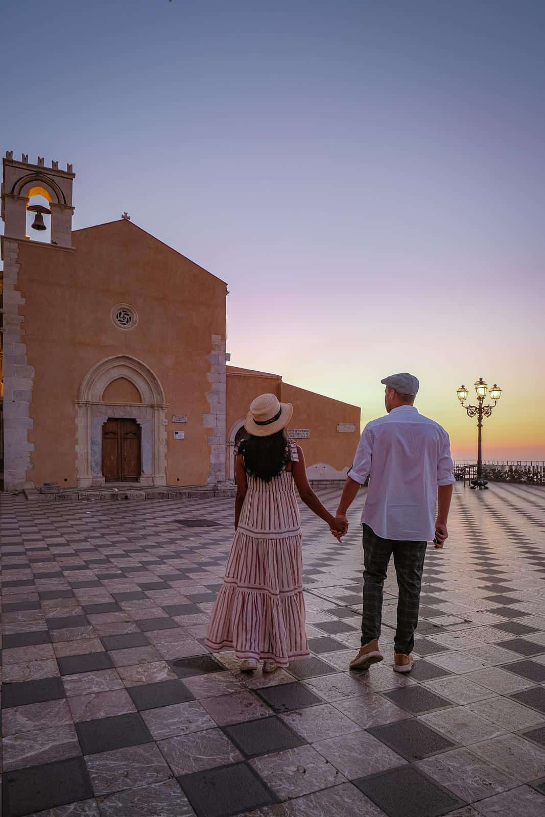 Couple in front of Italian Church - Places to take a babymoon in Italy