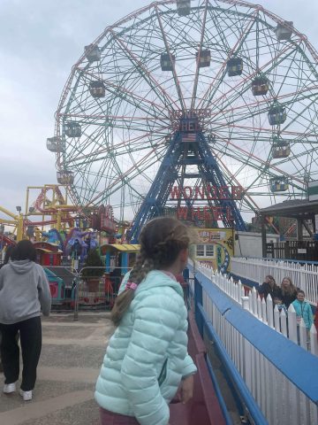 Girl in front of Wonder Wheel Coney Island