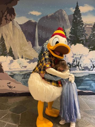 Donald Duck hugging a little girl