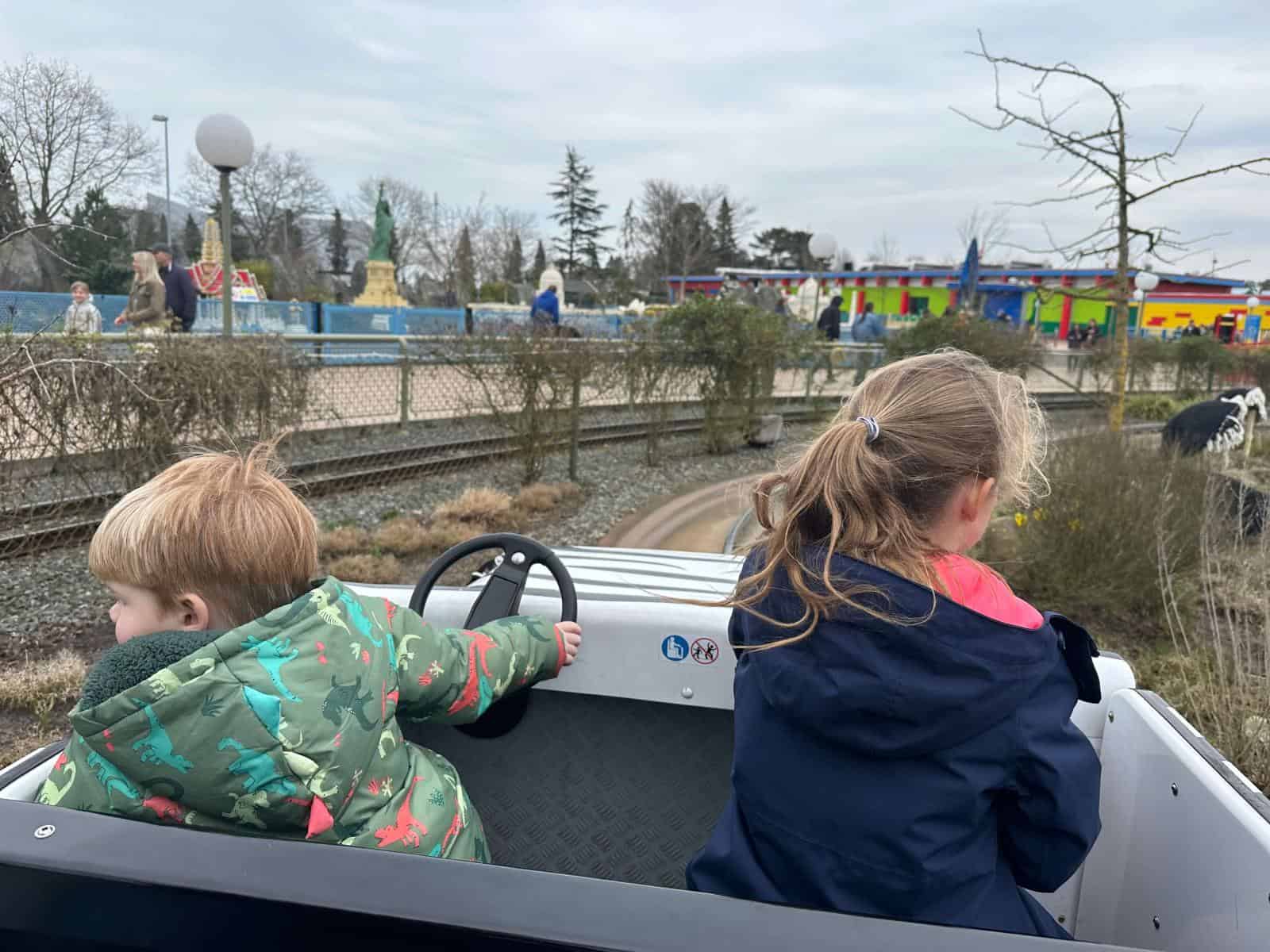 Two children driving a car at Legoland