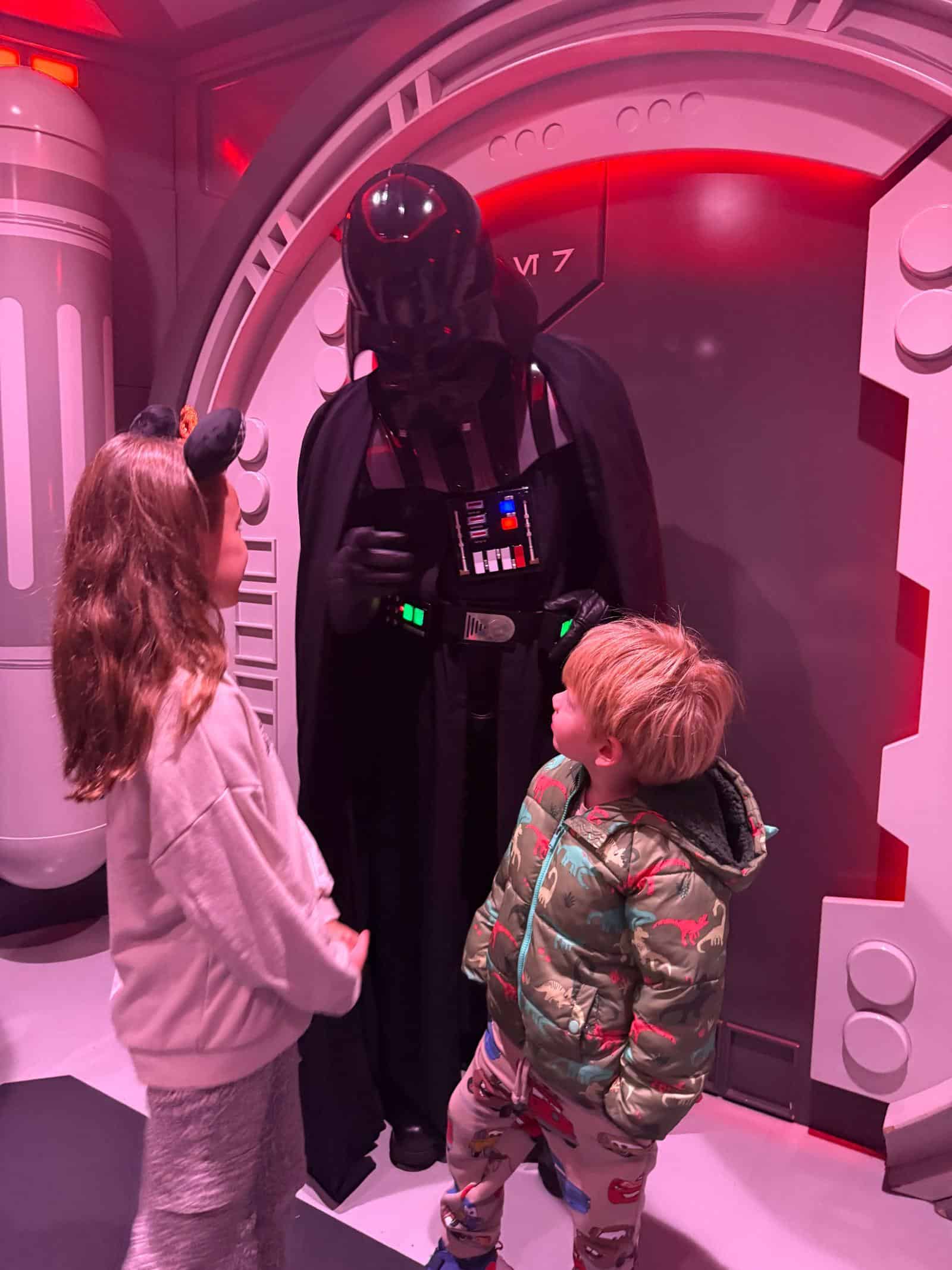 Two children meeting Darth Vader