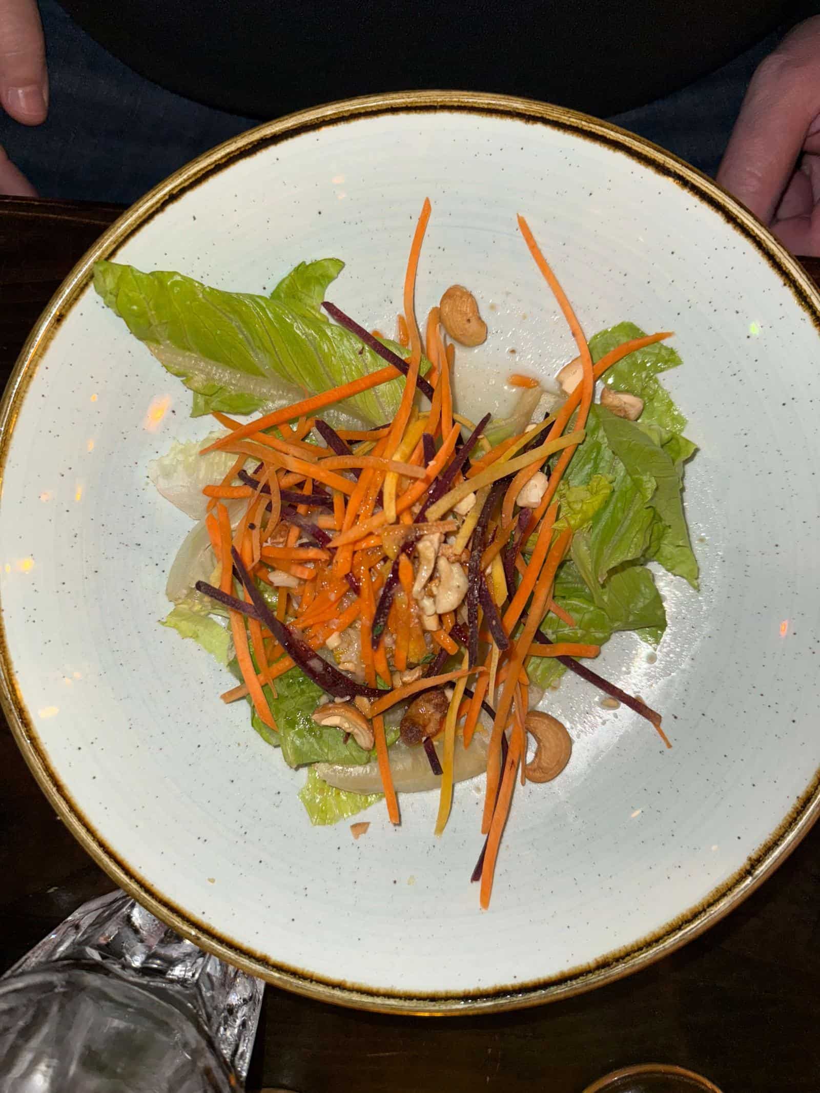 Smoked chicken papaya salad on white playe